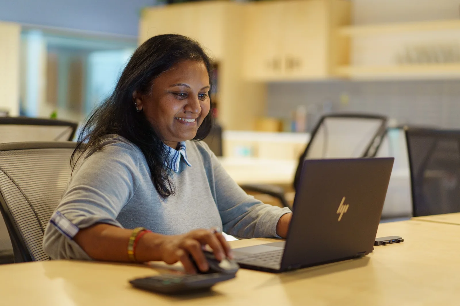 Kas from Keyzone working on a laptop at her desk